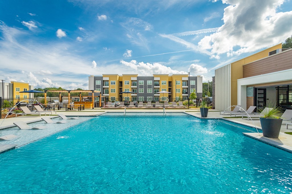 a swimming pool at a hotel with a blue sky