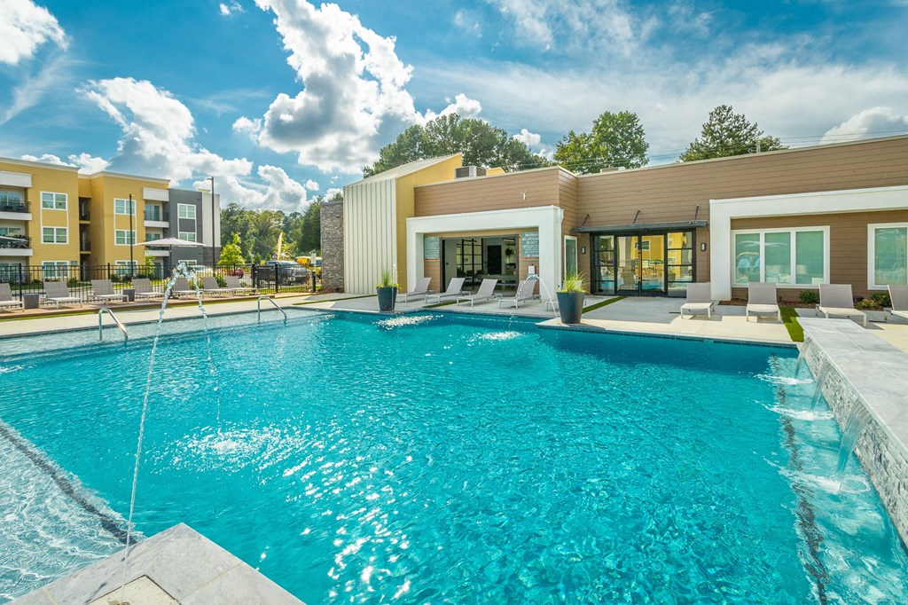 a swimming pool with a building in the background