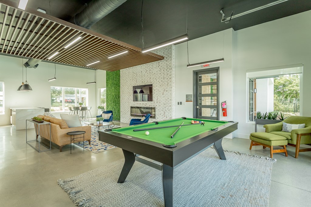 a pool table in the lobby of a house with