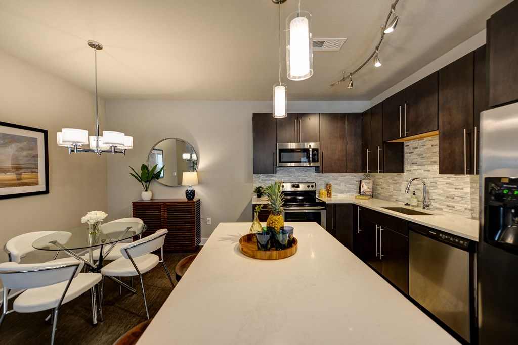 kitchen and dining area at the district flats apartments in lenexa