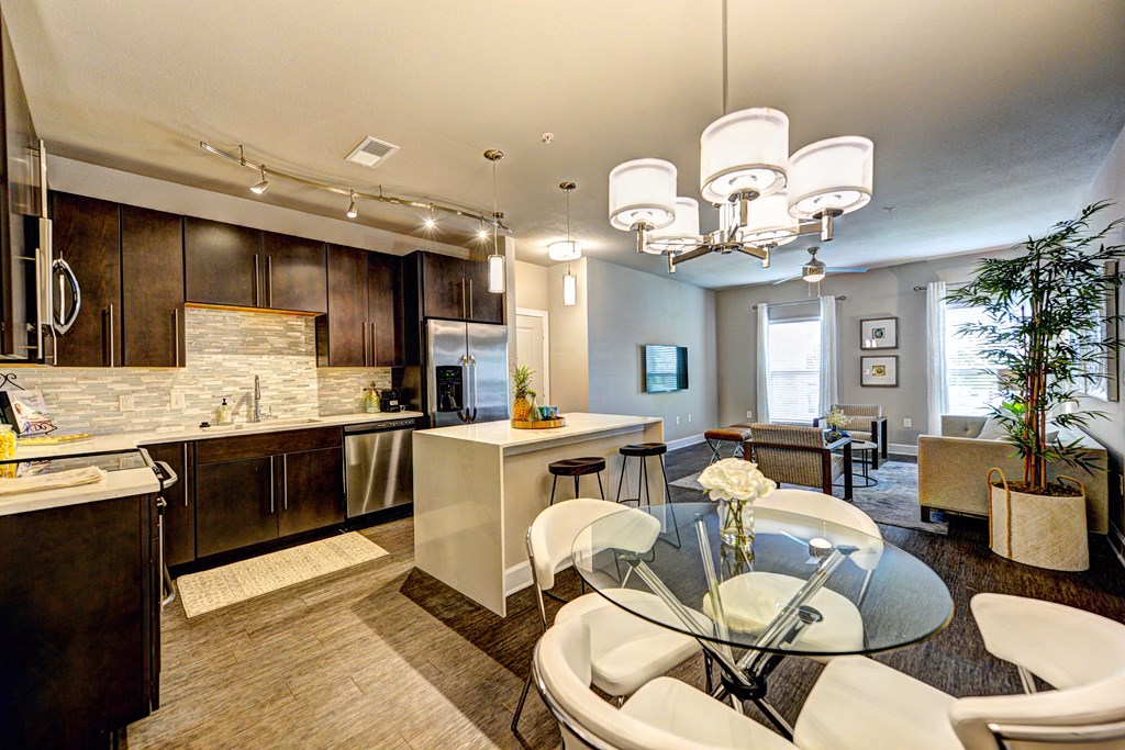 a kitchen and dining room with a table and chairs
