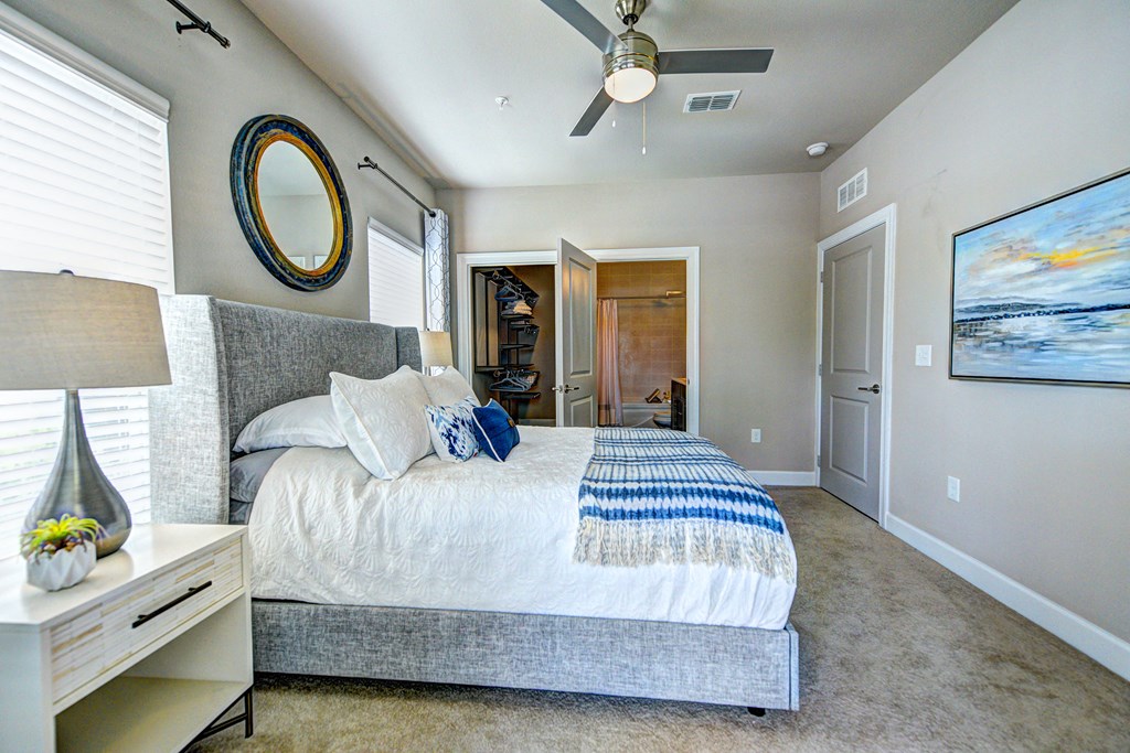 a bedroom with a large bed and a ceiling fan
