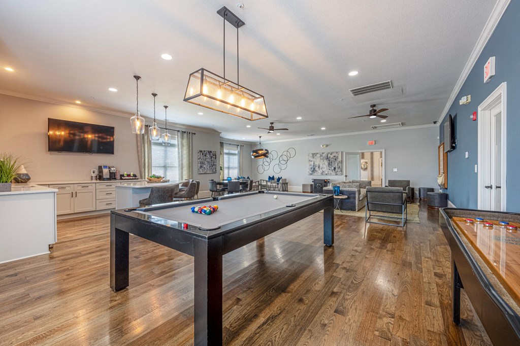 a game room with a pool table and a bar