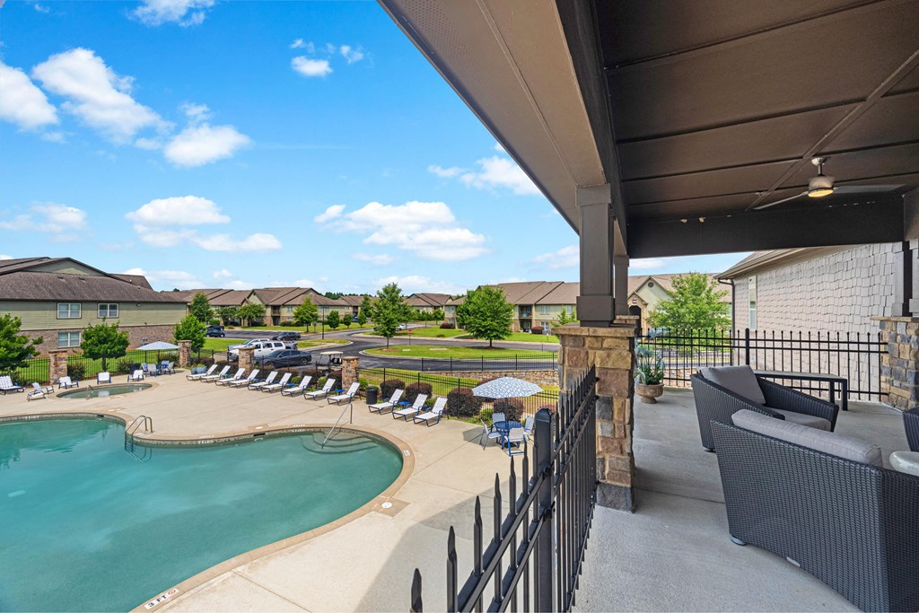 the outlook of a resort style pool with chairs and umbrellas