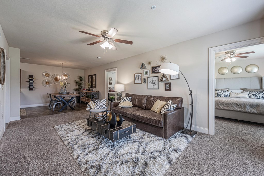 a living room with a couch and a ceiling fan