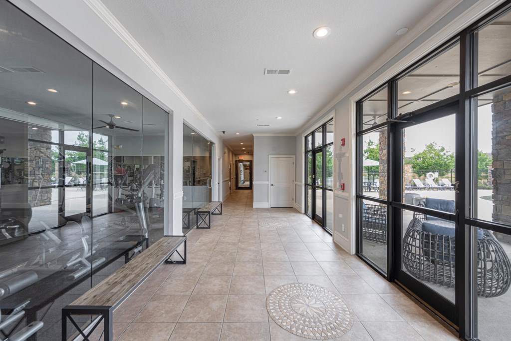 the lobby of a condo with glass doors and windows