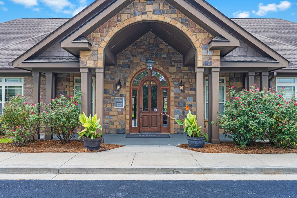the front of a brick house with a wooden door