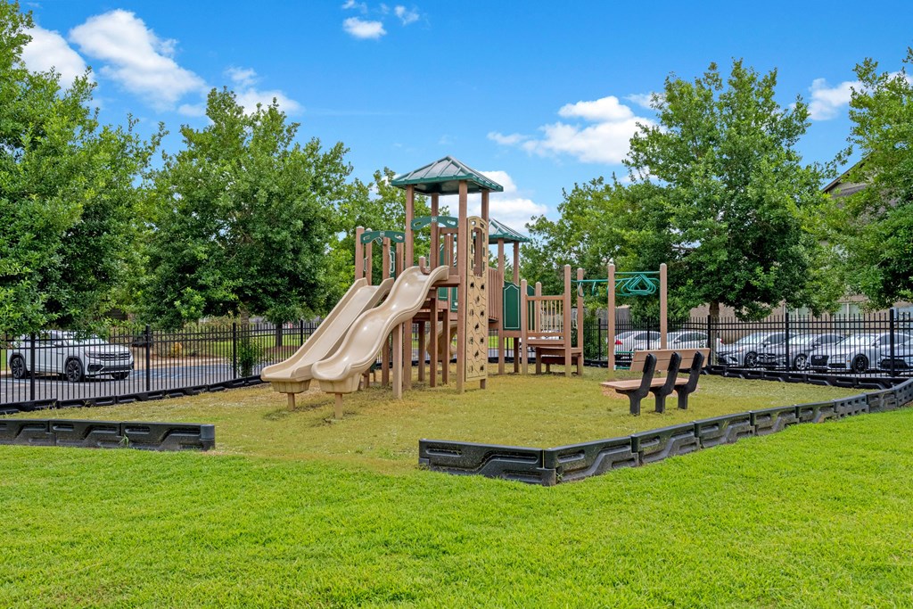 a playground with a jungle gym and slides in a park