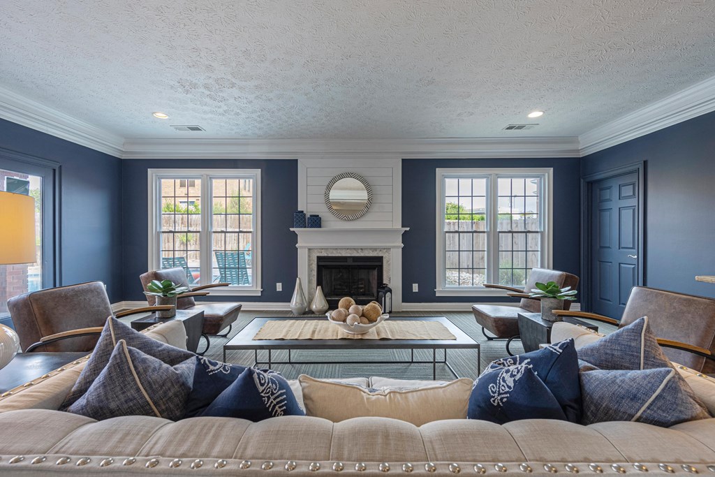 a living room with blue walls and a white fireplace