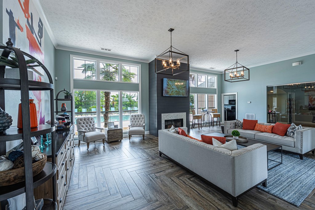 a living room with couches and chairs and a fireplace