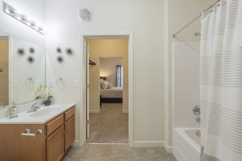 a bathroom with a shower and a sink and a mirror