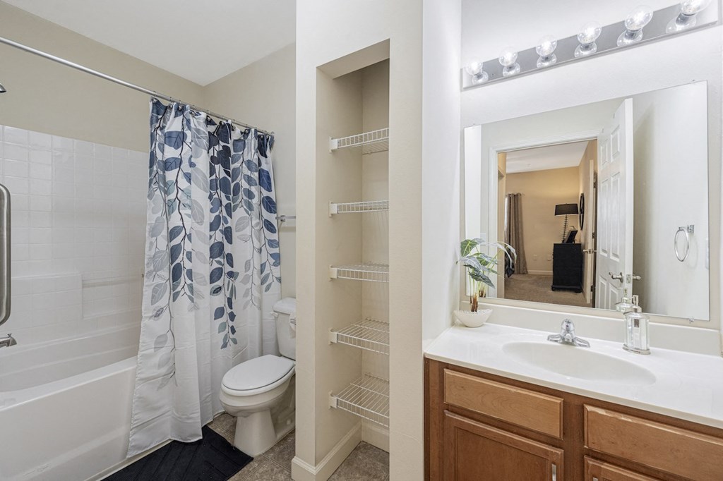 a bathroom with a shower and a sink and a toilet