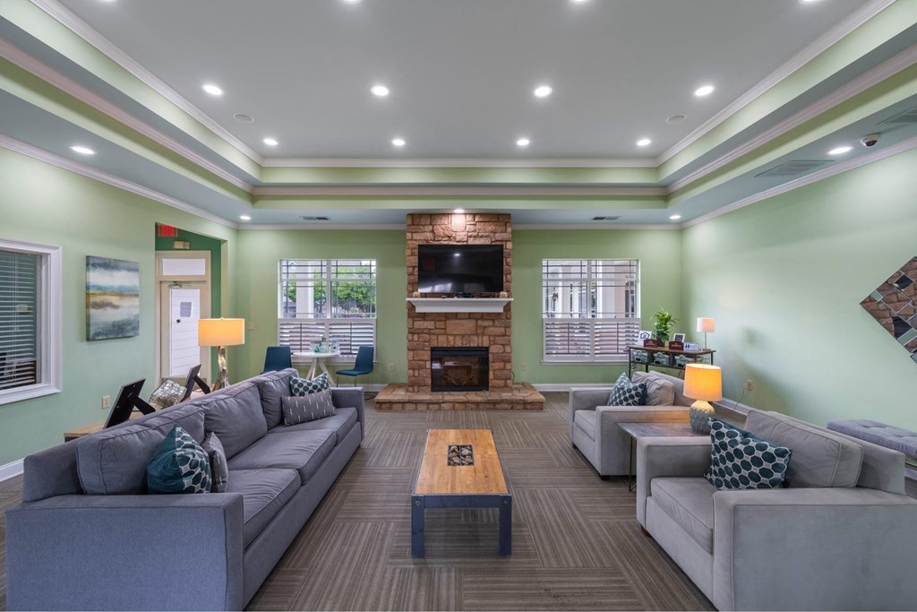 a large living room with couches and a fireplace