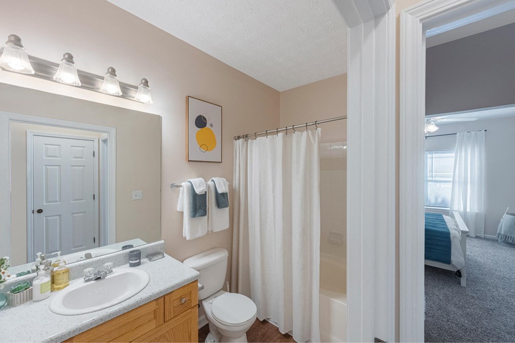 a bathroom with a shower and a sink and a toilet