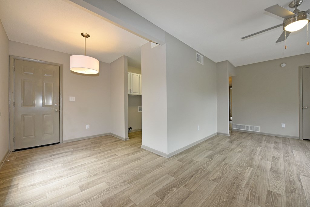 a bedroom with hardwood flooring and a ceiling fan
