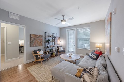 a living room with a couch and a ceiling fan