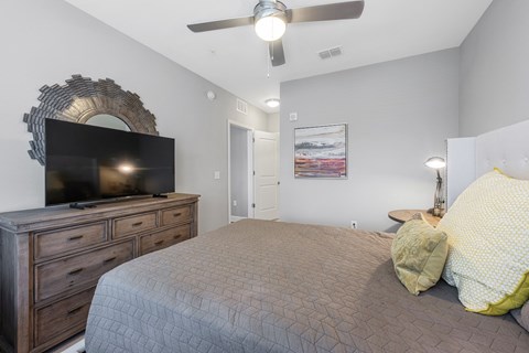 a bedroom with a bed and a tv