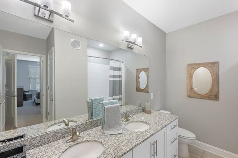 a bathroom with two sinks and a mirror