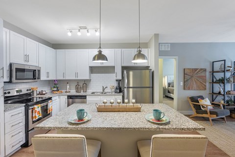 a kitchen and dining room with a table and chairs