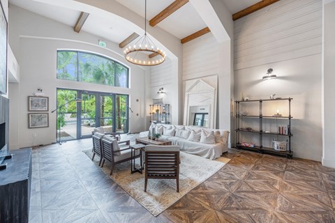 a living room with a couch and a table and a large window