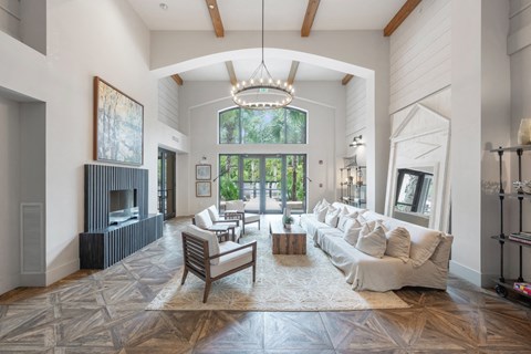 a living room with a large white couch and a fireplace