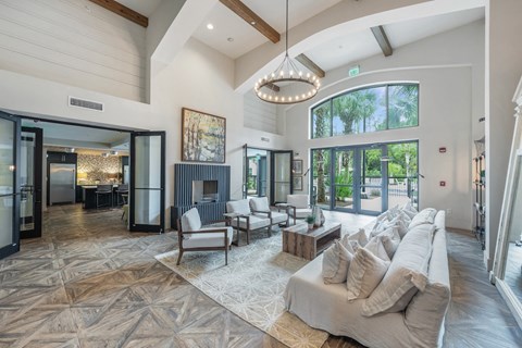 a living room with a couch and chairs and a fireplace