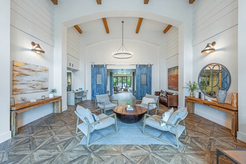 a living room with a table and chairs and a large window