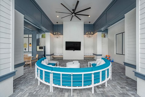 a clubhouse with a large blue pool and a television