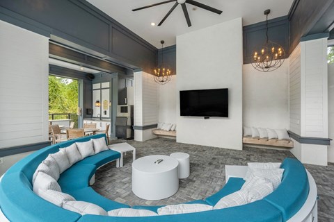 a living room with a blue couch and a television