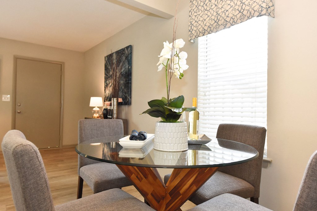a dining room with a table and chairs