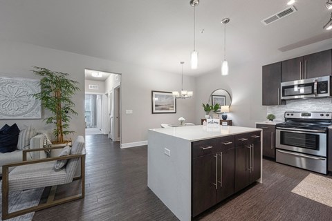 spacious kitchen with island and stainless steel appliances at the retreat at thousand oaks apartments