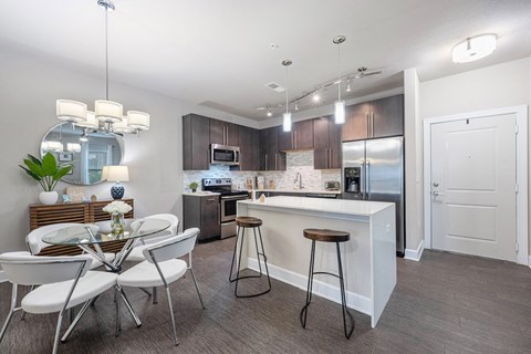a kitchen and dining area with a table and chairs