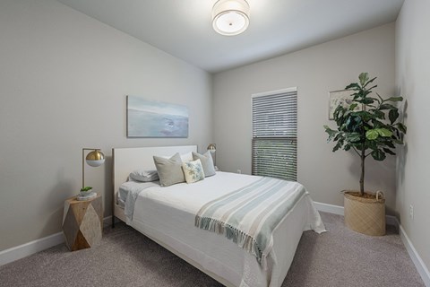 the preserve at ballantyne commons bedroom with bed and potted plant