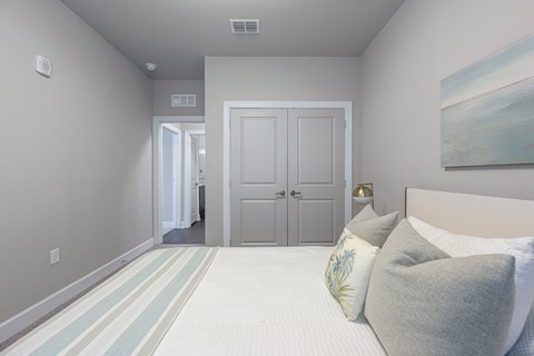a bedroom with a bed and a door to a bathroom