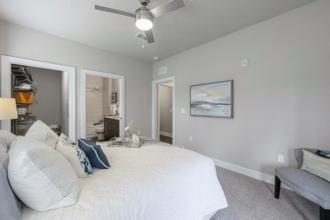 a bedroom with a large bed and a ceiling fan
