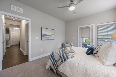 a bedroom with a large bed and a ceiling fan