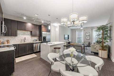 a kitchen and dining room with a glass table and chairs