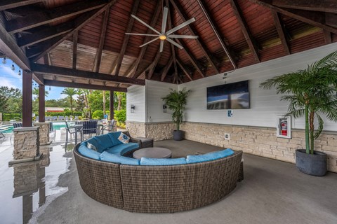 a patio with a couch and a table and a pool