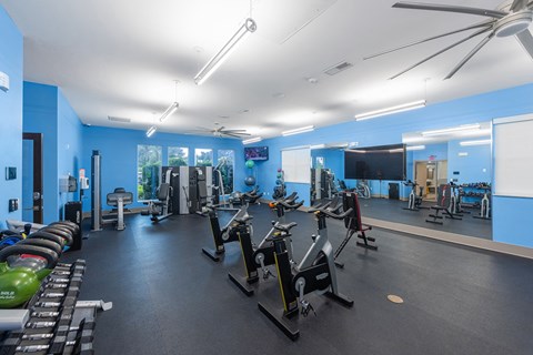 a fitness center with cardio equipment and weights in a gym