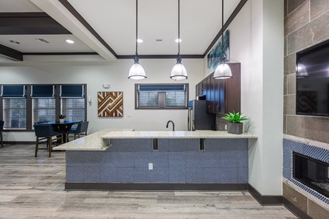 a large kitchen with a fireplace and a table with chairs