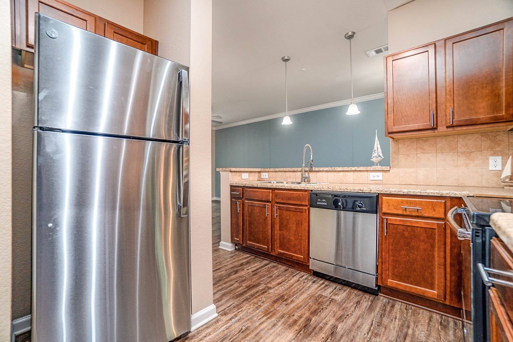 a kitchen with stainless steel appliances and wooden cabinets