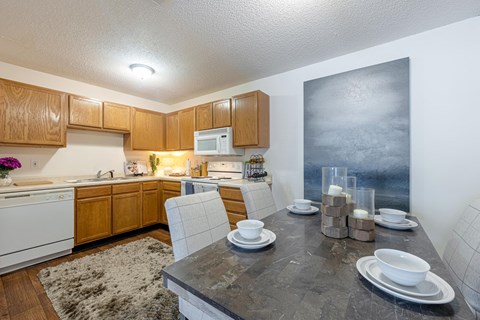 a kitchen and dining room with a table and chairs
