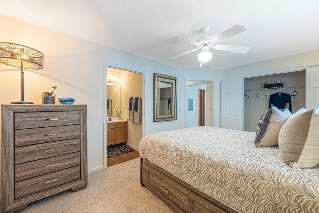 Bedroom with views into the bathroom and closet