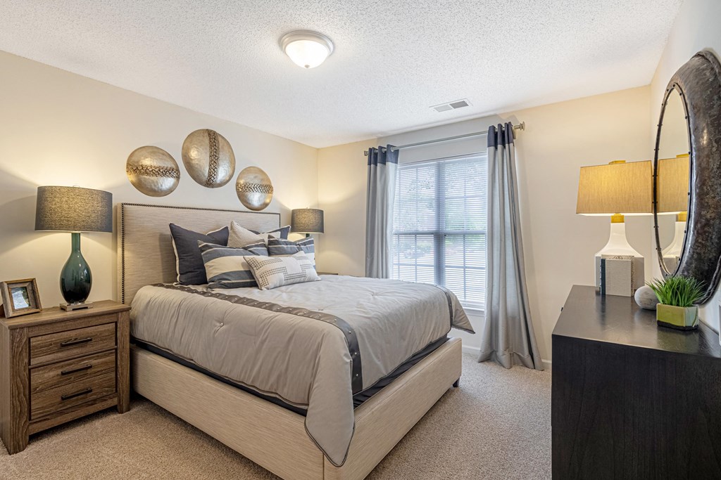 a bedroom with a large bed and a window