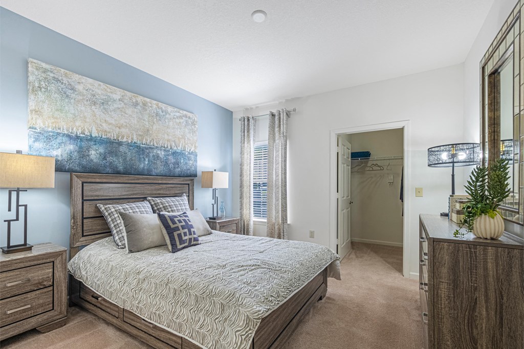 a bedroom with a bed and a painting on the wall