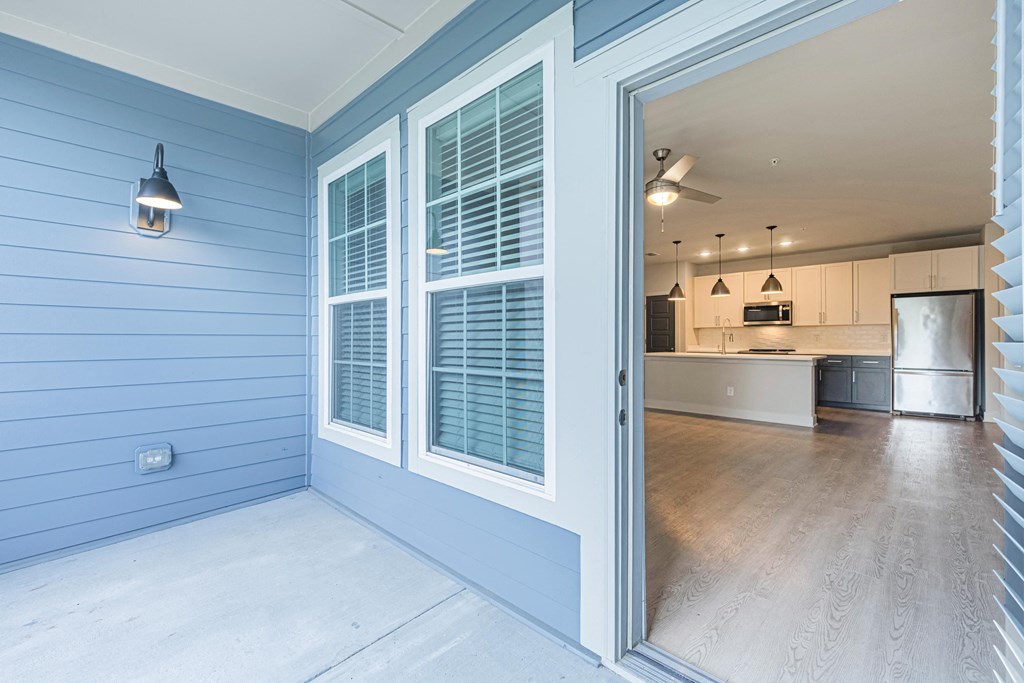 a view of the kitchen from the porch of a blue house