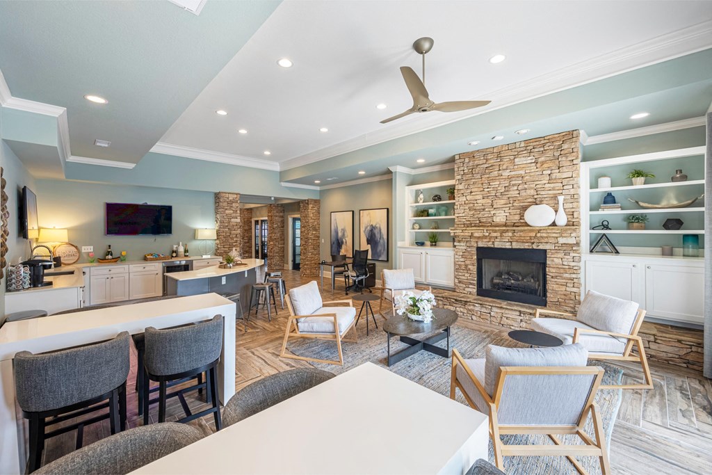 a living room with a fireplace and a table and chairs