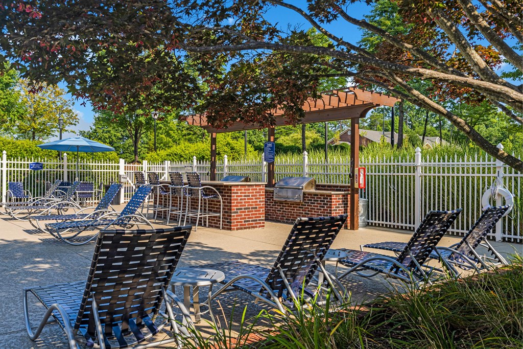a patio with chairs and tables and a gazebo