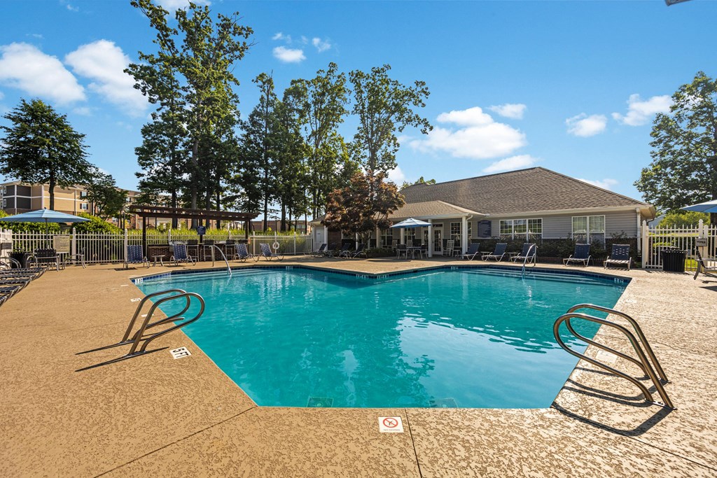 a swimming pool with a house in the background