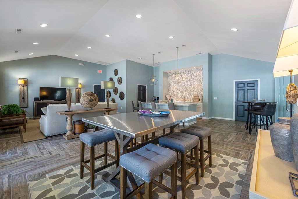a living room with a dining room table and chairs